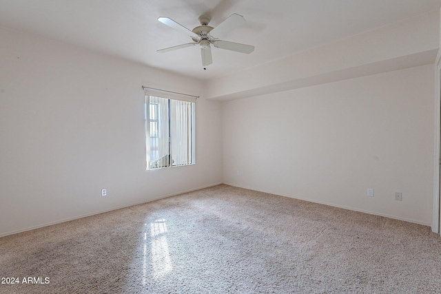 empty room with ceiling fan and carpet