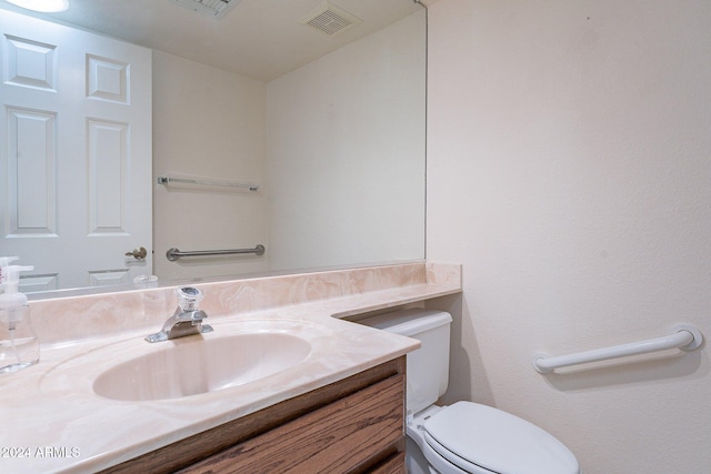 bathroom with vanity and toilet