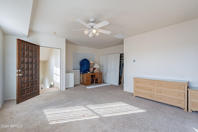 unfurnished bedroom featuring ceiling fan, white fridge, and light colored carpet