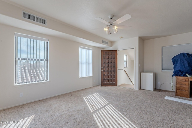 unfurnished bedroom with ceiling fan and light carpet