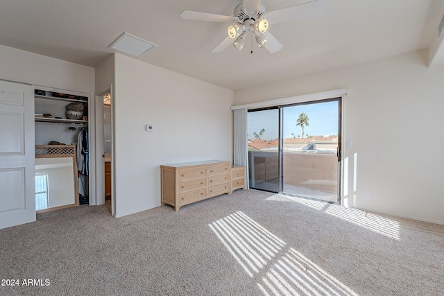 unfurnished bedroom with access to exterior, light colored carpet, a closet, and ceiling fan