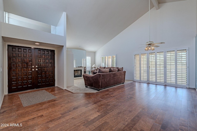 entrance foyer with beam ceiling, wood-type flooring, and high vaulted ceiling