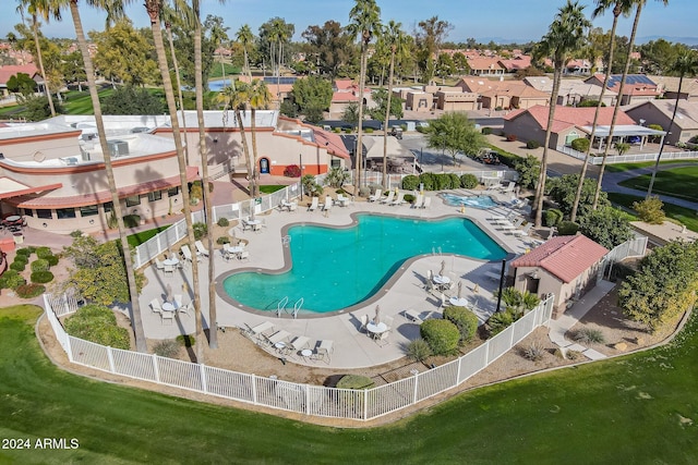 view of pool with a lawn