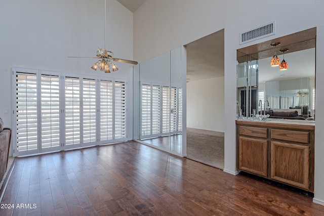 kitchen featuring dark wood-type flooring, ceiling fan, plenty of natural light, and hanging light fixtures