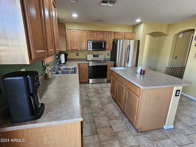 kitchen with sink, stainless steel appliances, and a center island