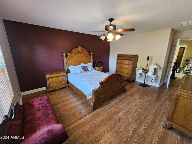 bedroom featuring wood-type flooring and ceiling fan