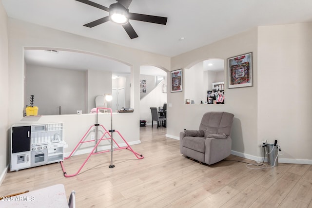 recreation room featuring light hardwood / wood-style floors and ceiling fan