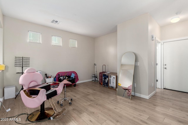 home office with light hardwood / wood-style flooring