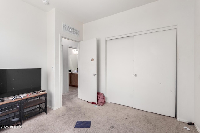 carpeted bedroom with a closet