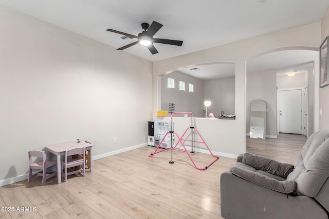 playroom with ceiling fan and light hardwood / wood-style floors