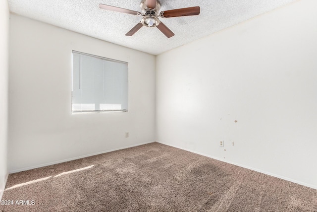 carpeted empty room with a ceiling fan, a textured ceiling, and baseboards