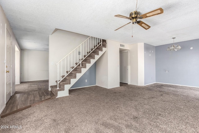 unfurnished living room with visible vents, stairs, a textured ceiling, carpet flooring, and ceiling fan with notable chandelier