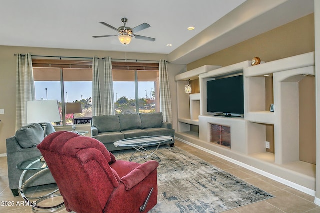 tiled living room featuring built in shelves and ceiling fan