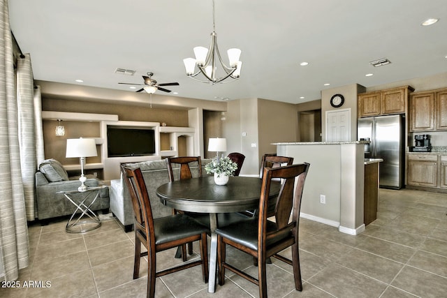 tiled dining area featuring ceiling fan with notable chandelier