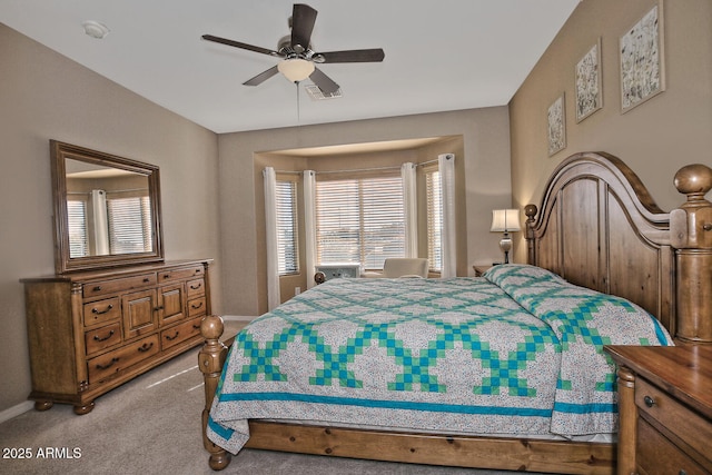 bedroom with ceiling fan and light colored carpet