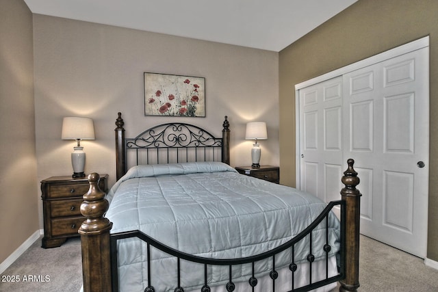 bedroom featuring light carpet and a closet