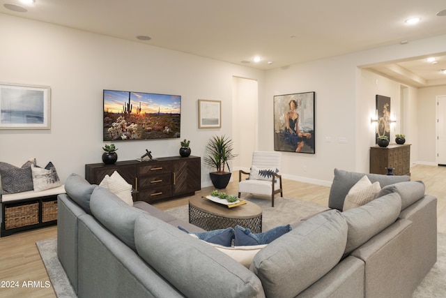 living area featuring light wood-type flooring, baseboards, and recessed lighting
