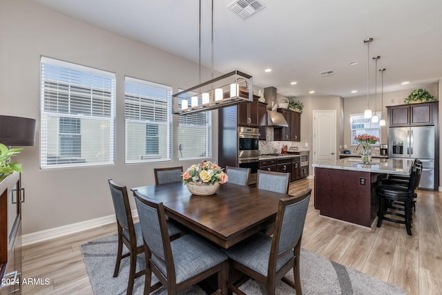 dining room with light hardwood / wood-style flooring