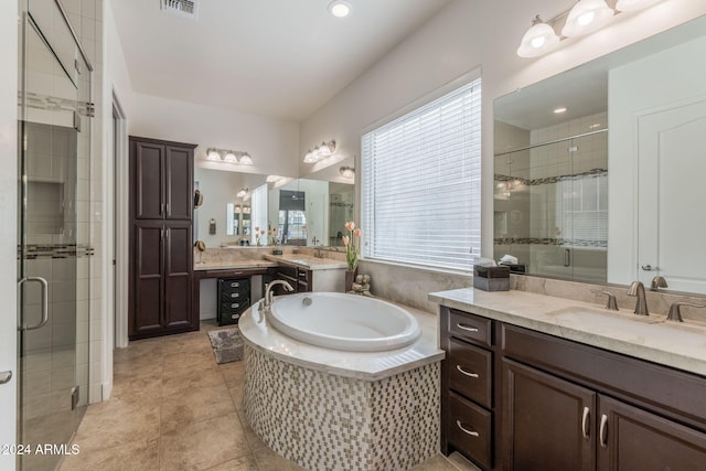 bathroom with tile patterned flooring, vanity, and plus walk in shower