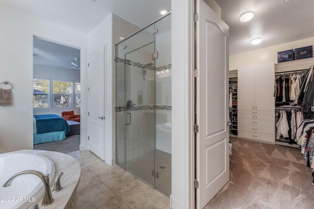 bathroom featuring tile patterned floors and separate shower and tub