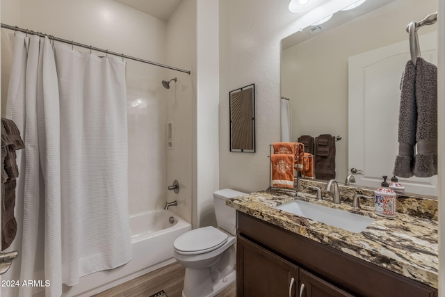 full bathroom featuring vanity, hardwood / wood-style flooring, toilet, and shower / bath combo with shower curtain