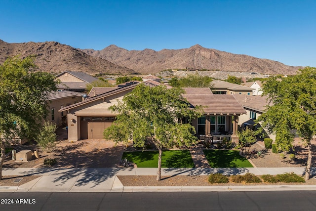 view of front of home with a mountain view and a garage