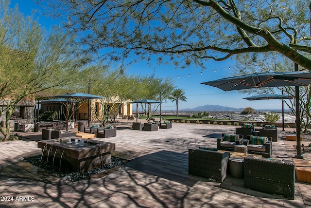 exterior space with a mountain view, an outdoor living space with a fire pit, and a patio area