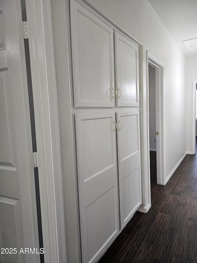 corridor with baseboards and dark wood-style flooring