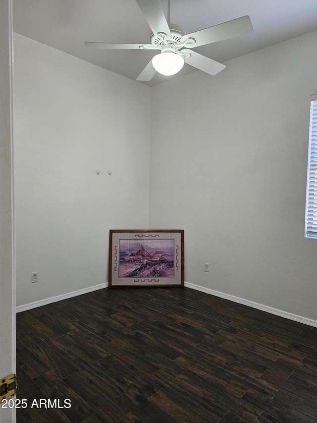 spare room featuring ceiling fan, baseboards, and wood finished floors