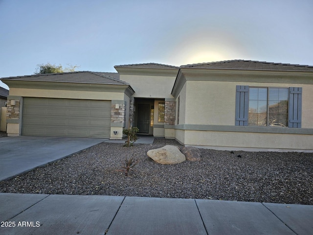 view of front of property featuring stone siding, stucco siding, driveway, and a garage