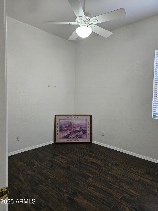 empty room with a ceiling fan, baseboards, and wood finished floors