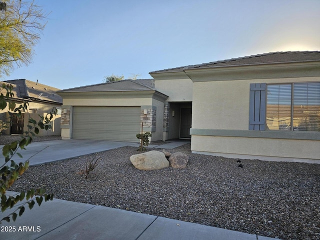 view of front of house with concrete driveway, an attached garage, and stone siding