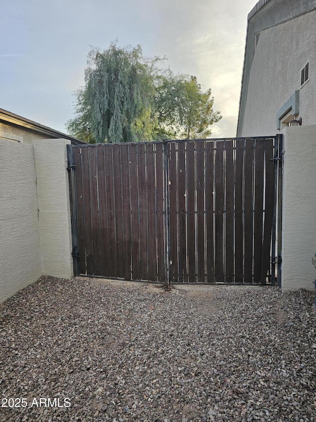 view of gate featuring fence