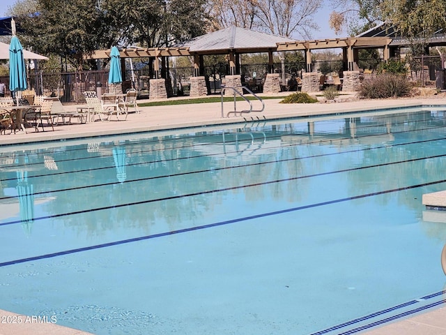 pool featuring a patio area, a pergola, and fence