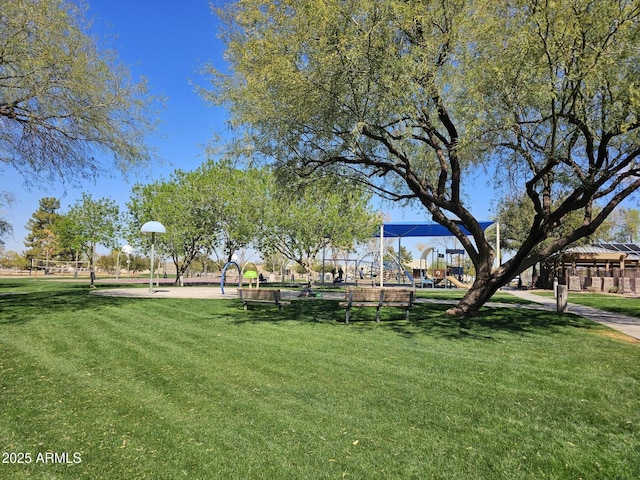 view of community featuring playground community and a yard