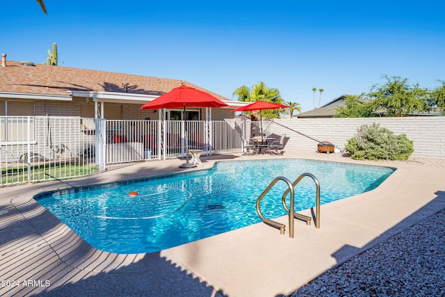 view of swimming pool with a patio