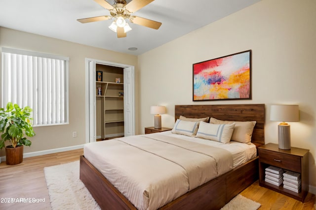 1342 W Emerald Ave Unit 286, Mesa, AZ 85202 - bedroom featuring light wood-type flooring, a closet, baseboards, and a ceiling fan