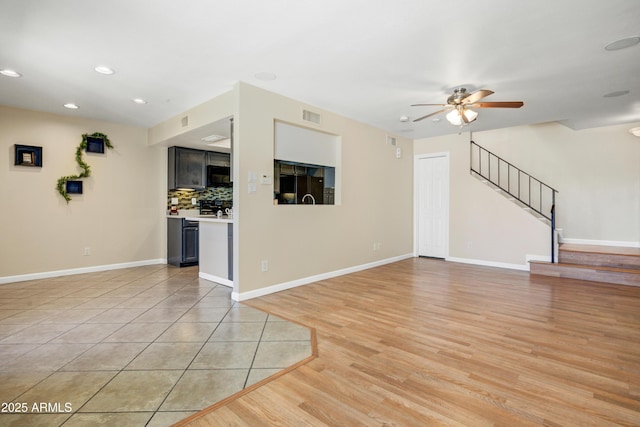 1342 W Emerald Ave Unit 286, Mesa, AZ 85202 - unfurnished living room featuring a ceiling fan, stairs, recessed lighting, baseboards, and light wood-style floors