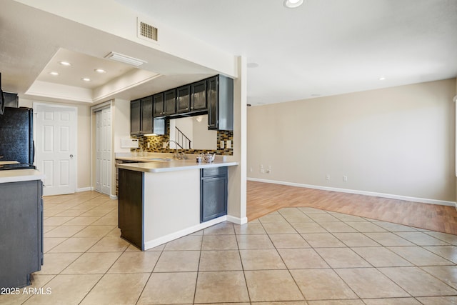 1342 W Emerald Ave Unit 286, Mesa, AZ 85202 - kitchen featuring freestanding refrigerator, light countertops, light tile patterned floors, recessed lighting, and baseboards