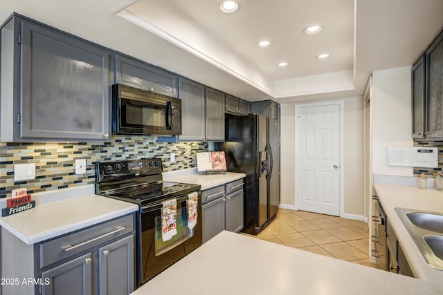 1342 W Emerald Ave Unit 286, Mesa, AZ 85202 - kitchen with black appliances, a raised ceiling, light tile patterned floors, tasteful backsplash, and light countertops