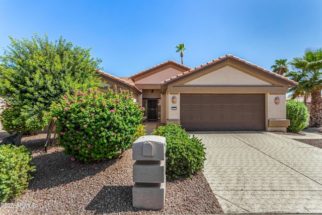 15011 W Verde Ln, Goodyear, AZ 85395 - view of front facade with an attached garage, driveway, stucco siding, and a tile roof