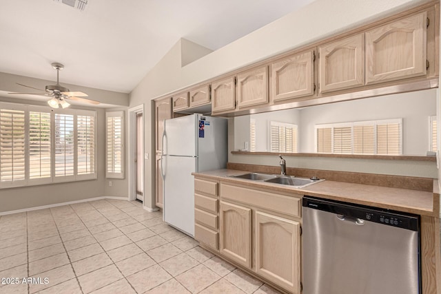 15011 W Verde Ln, Goodyear, AZ 85395 - kitchen featuring dishwasher, freestanding refrigerator, lofted ceiling, light brown cabinets, and light tile patterned flooring