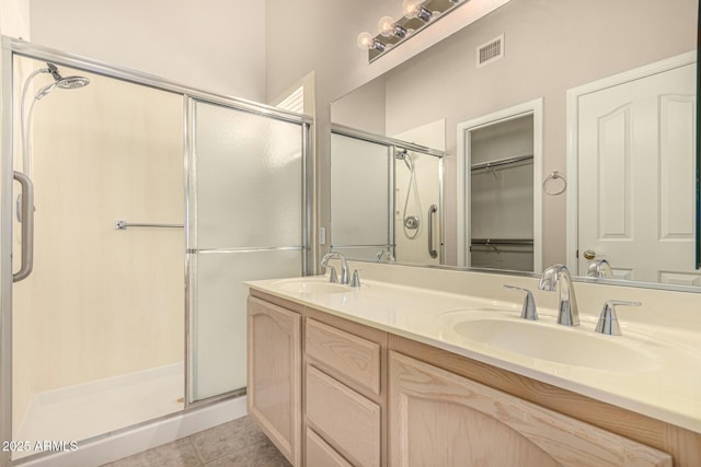 15011 W Verde Ln, Goodyear, AZ 85395 - bathroom with a shower stall, double vanity, tile patterned floors, and a walk in closet