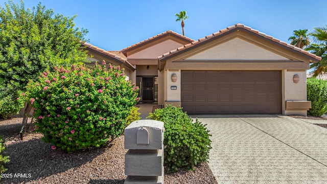 15011 W Verde Ln, Goodyear, AZ 85395 - view of front of property featuring a garage, driveway, stucco siding, and a tiled roof