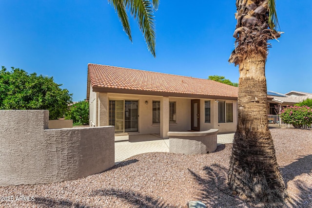 15011 W Verde Ln, Goodyear, AZ 85395 - rear view of house featuring a tile roof, stucco siding, and a patio area