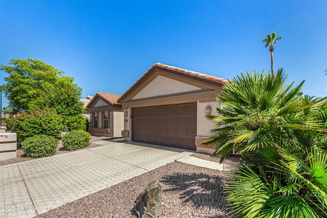 15011 W Verde Ln, Goodyear, AZ 85395 - ranch-style home with stucco siding, a tiled roof, a garage, and decorative driveway