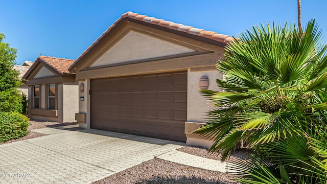15011 W Verde Ln, Goodyear, AZ 85395 - view of front of home with stucco siding, a tiled roof, a garage, and driveway