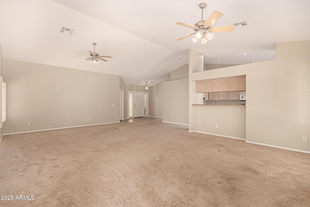15011 W Verde Ln, Goodyear, AZ 85395 - unfurnished living room featuring a ceiling fan, vaulted ceiling, and light carpet