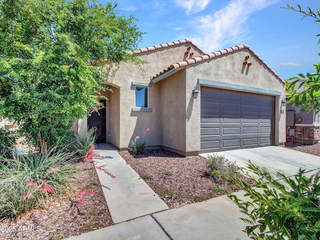 14160 W Georgia Dr, Surprise, AZ 85379 - mediterranean / spanish-style house featuring stucco siding, an attached garage, concrete driveway, and a tile roof