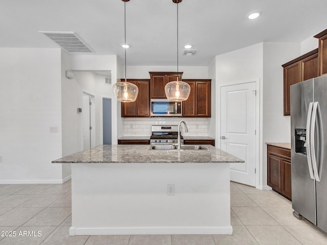 14160 W Georgia Dr, Surprise, AZ 85379 - kitchen featuring appliances with stainless steel finishes, a sink, decorative backsplash, light stone countertops, and recessed lighting